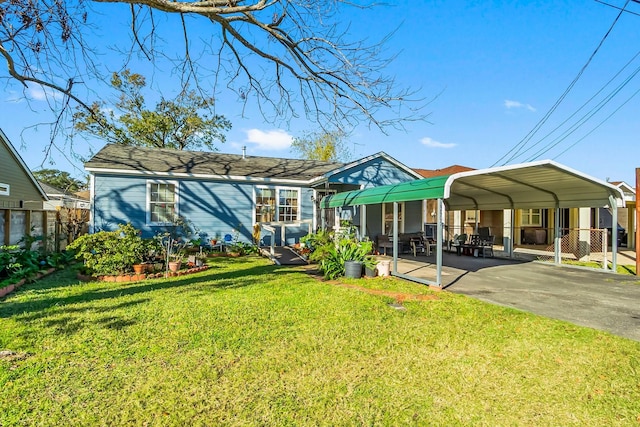 back of house with a yard and a carport