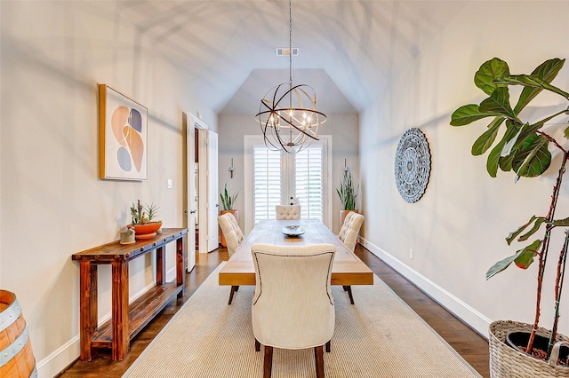 dining space with a chandelier, dark hardwood / wood-style flooring, french doors, and vaulted ceiling