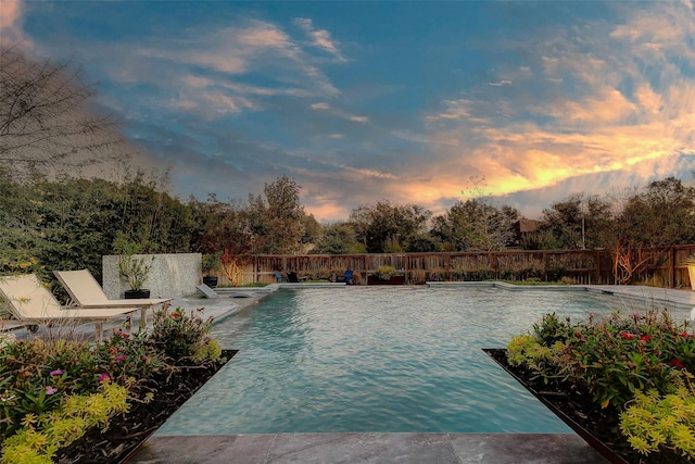 view of pool at dusk