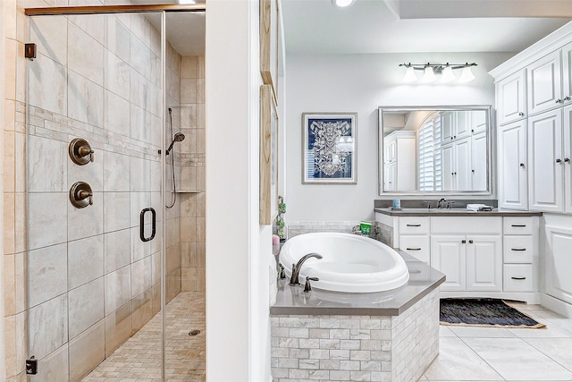 bathroom with tile patterned floors, vanity, and shower with separate bathtub