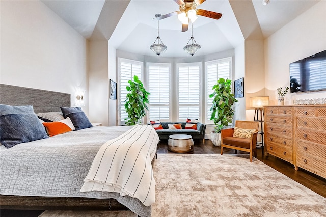 bedroom featuring hardwood / wood-style flooring, ceiling fan, and lofted ceiling