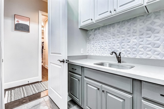 kitchen featuring gray cabinets and sink