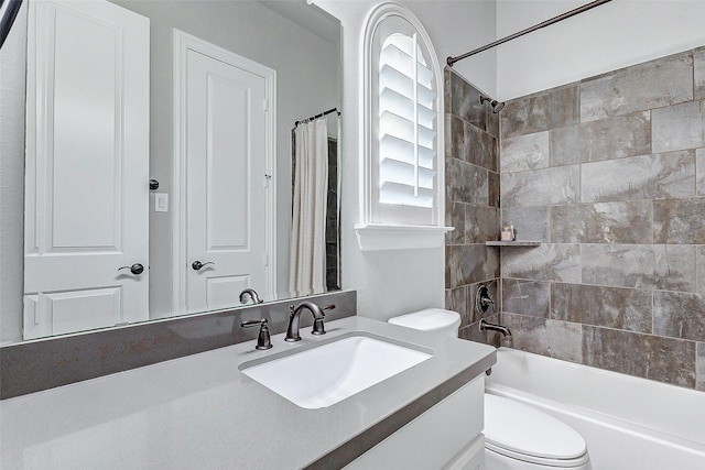 full bathroom featuring shower / bath combo, vanity, and toilet