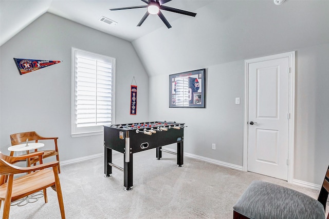 rec room featuring ceiling fan, light colored carpet, and vaulted ceiling