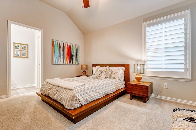 carpeted bedroom with ceiling fan and vaulted ceiling