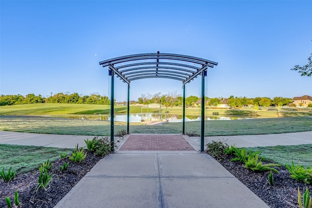 view of property's community featuring a water view and a lawn