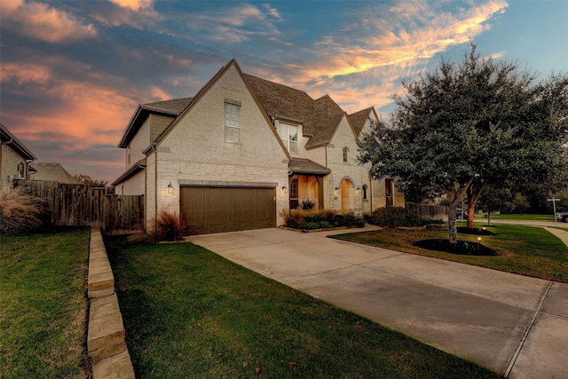 view of front of property with a yard and a garage