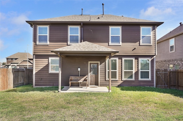 rear view of property with a patio and a lawn