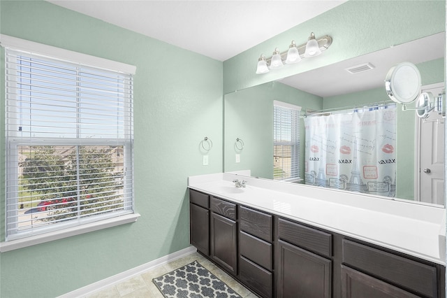 bathroom with tile patterned flooring, vanity, plenty of natural light, and curtained shower