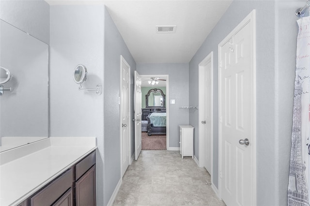 bathroom featuring vanity and ceiling fan