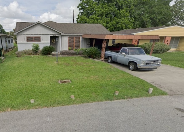 ranch-style house featuring a carport and a front yard