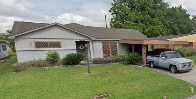 ranch-style house with a carport and a front yard