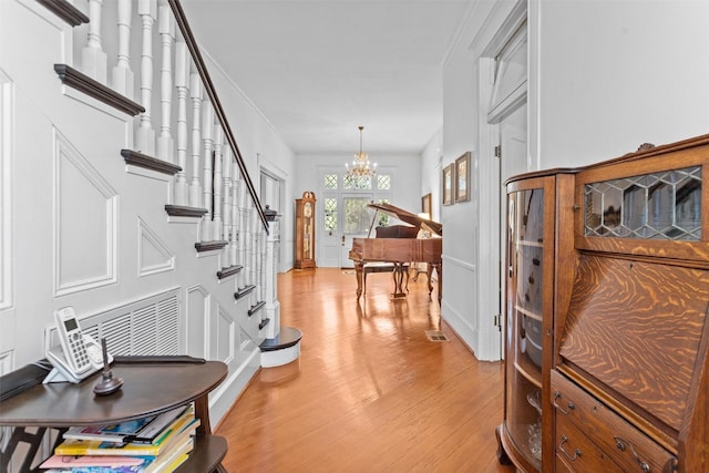 foyer with a chandelier and light hardwood / wood-style floors