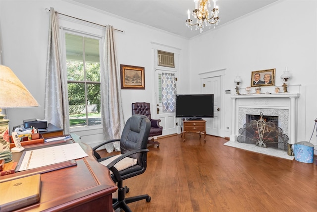 office featuring hardwood / wood-style floors, crown molding, a high end fireplace, and an inviting chandelier