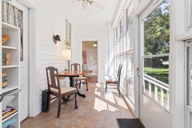 sunroom featuring ceiling fan