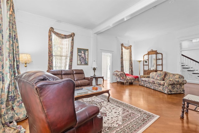 living room with beam ceiling and wood-type flooring