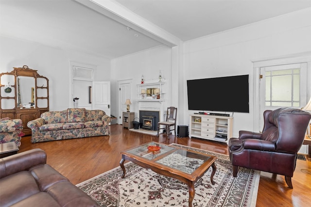 living room featuring beamed ceiling and hardwood / wood-style flooring