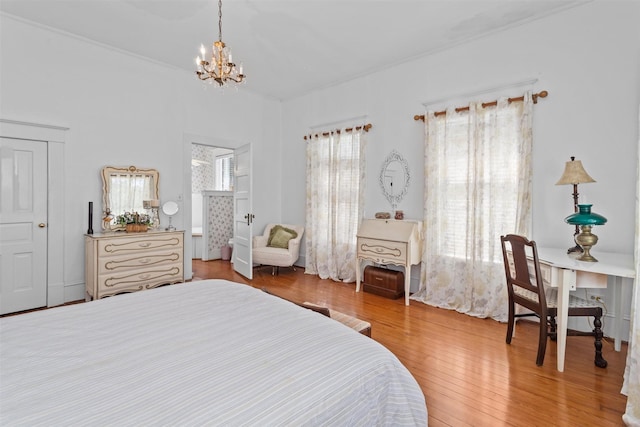 bedroom featuring a chandelier and wood-type flooring