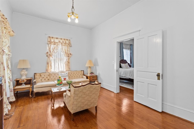 sitting room featuring hardwood / wood-style flooring, a notable chandelier, and a wealth of natural light