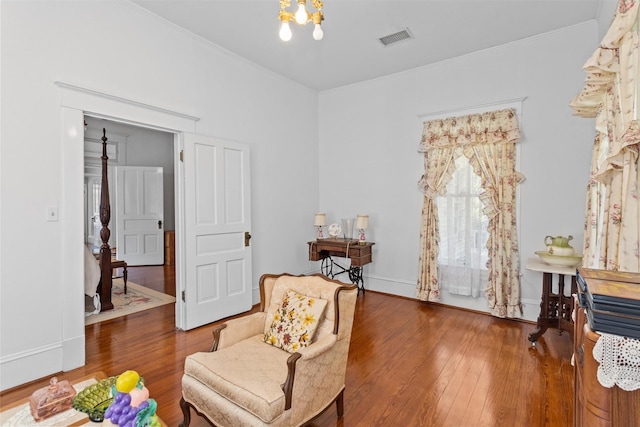 sitting room featuring hardwood / wood-style floors and a notable chandelier