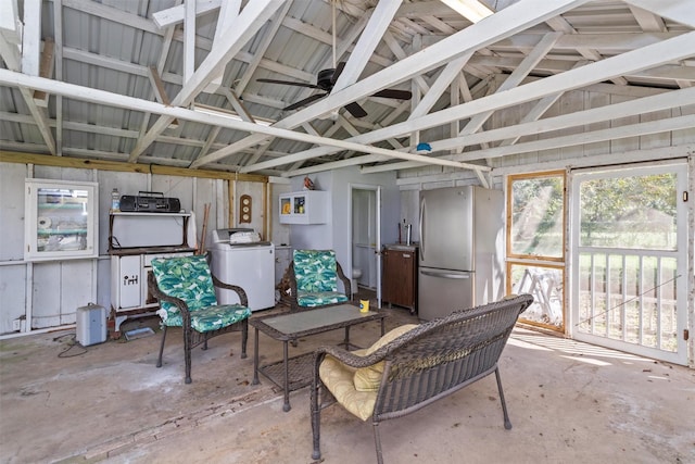 sunroom with washing machine and clothes dryer, ceiling fan, and lofted ceiling