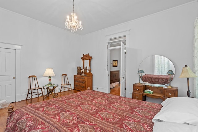 bedroom with a chandelier and hardwood / wood-style floors