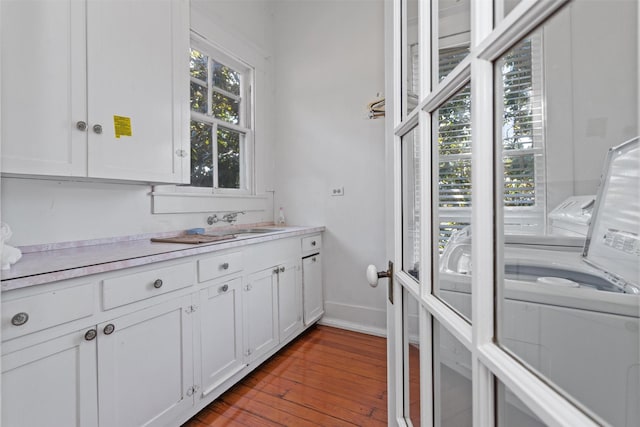 kitchen featuring light hardwood / wood-style floors, white cabinetry, and sink