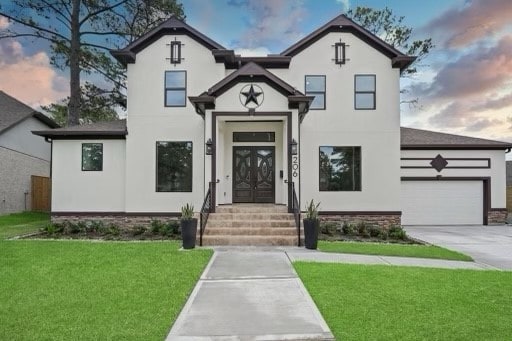 french country inspired facade featuring a garage and a lawn