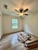 unfurnished bedroom featuring ceiling fan and wood-type flooring