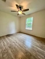 empty room featuring ceiling fan and hardwood / wood-style flooring