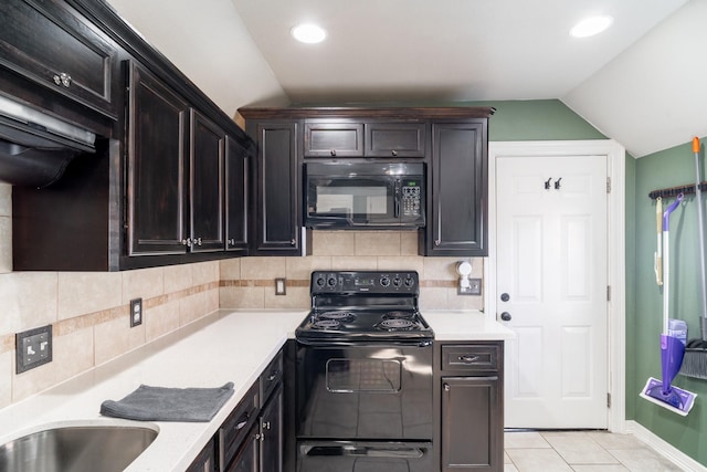 kitchen with tasteful backsplash, light tile patterned flooring, black appliances, and vaulted ceiling