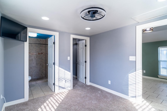 unfurnished bedroom with ensuite bath and light tile patterned flooring