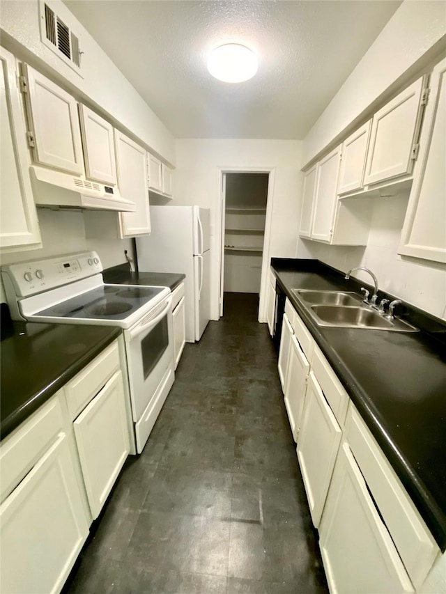 kitchen featuring sink, white appliances, white cabinets, and a textured ceiling