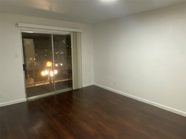 unfurnished room featuring dark hardwood / wood-style floors