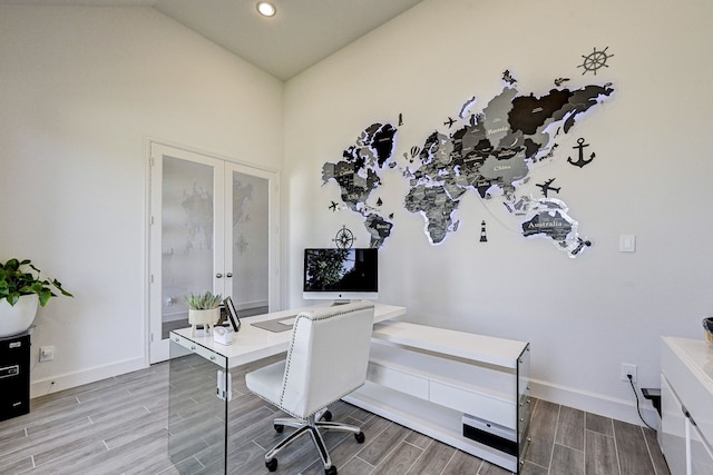 office featuring baseboards, french doors, vaulted ceiling, and wood tiled floor