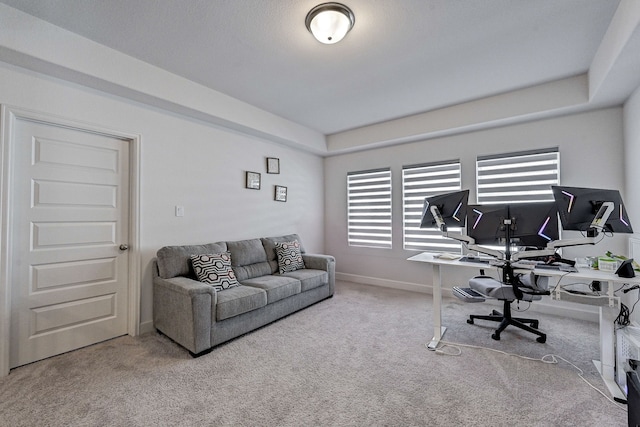 carpeted home office with baseboards