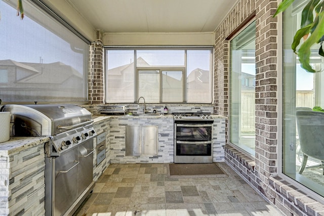 view of patio with grilling area, a sink, and area for grilling