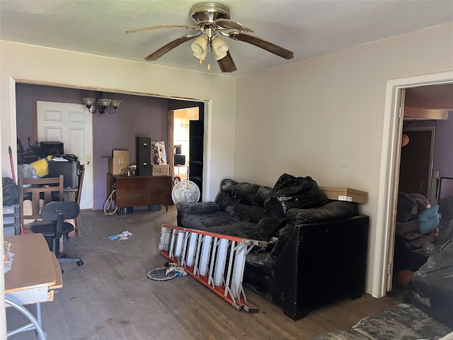 living room with wood-type flooring and ceiling fan with notable chandelier