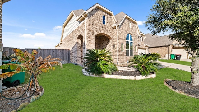 view of front of home featuring a garage and a front lawn