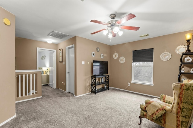 sitting room with ceiling fan and light colored carpet