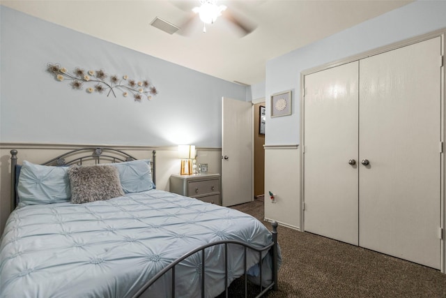 carpeted bedroom with ceiling fan and a closet