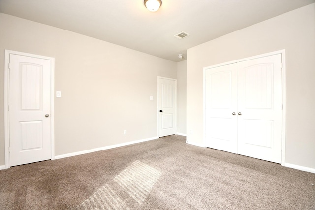 unfurnished bedroom featuring carpet floors and a closet