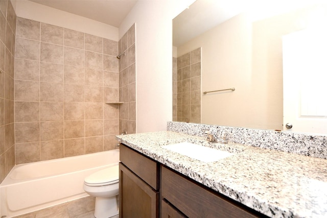 full bathroom featuring tile patterned flooring, vanity, tiled shower / bath combo, and toilet