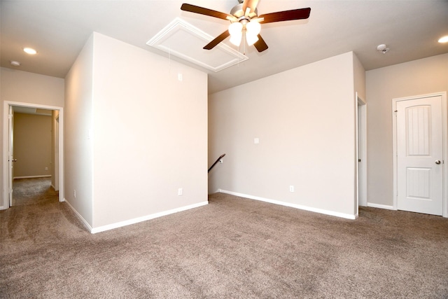 empty room with ceiling fan and dark colored carpet