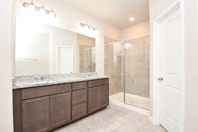 bathroom featuring tile patterned flooring, vanity, and walk in shower