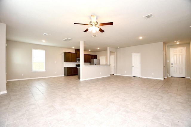 unfurnished living room featuring ceiling fan