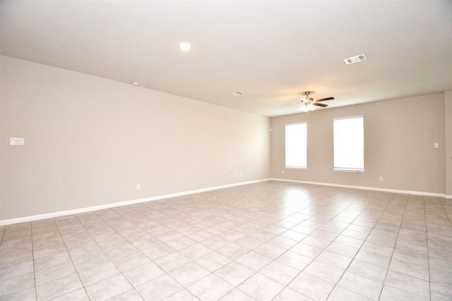 tiled empty room with ceiling fan