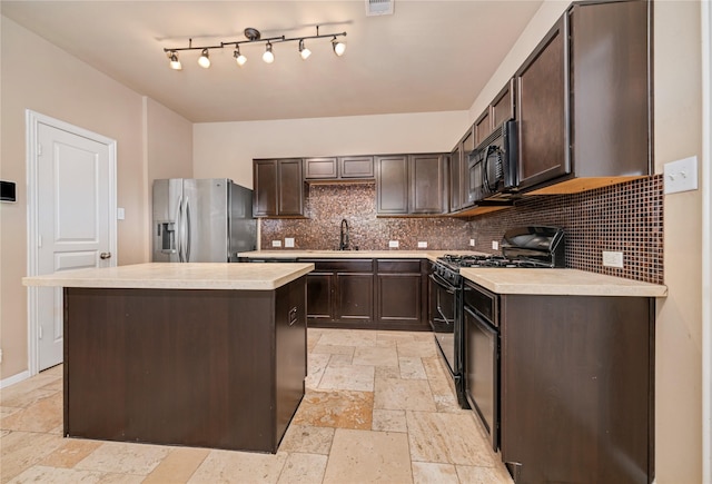 kitchen featuring black appliances, a center island, sink, and dark brown cabinetry