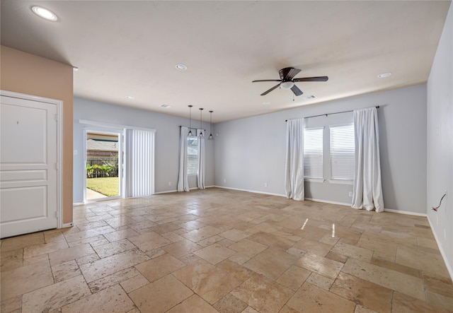 empty room featuring ceiling fan and a healthy amount of sunlight