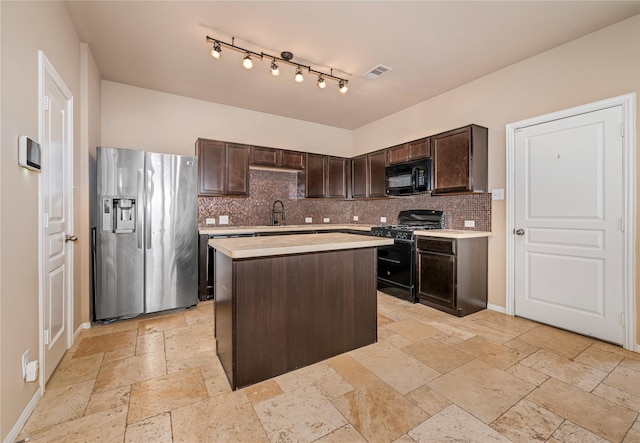 kitchen with black appliances, tasteful backsplash, a kitchen island, dark brown cabinetry, and sink